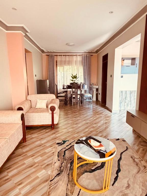 a living room with a couch and a table at Excutive suites in Kyebando