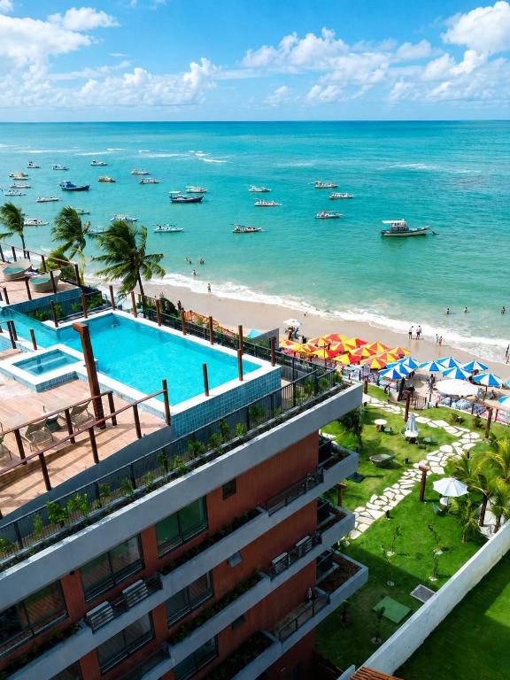 a view of the beach from the balcony of a building at Smeralda del Mare by AFT in Porto De Galinhas