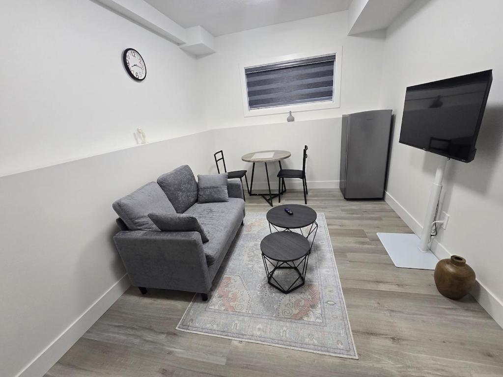 a living room with a couch and a table at The Vilaskan in Saskatoon