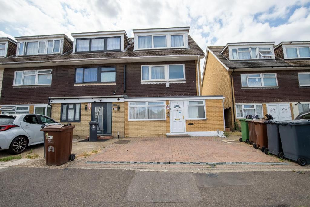 a house with a car parked in front of it at Spacious 5Bedroom Home with Garden & Parking Sleeps 11 Near Elizabeth Line in Goodmayes