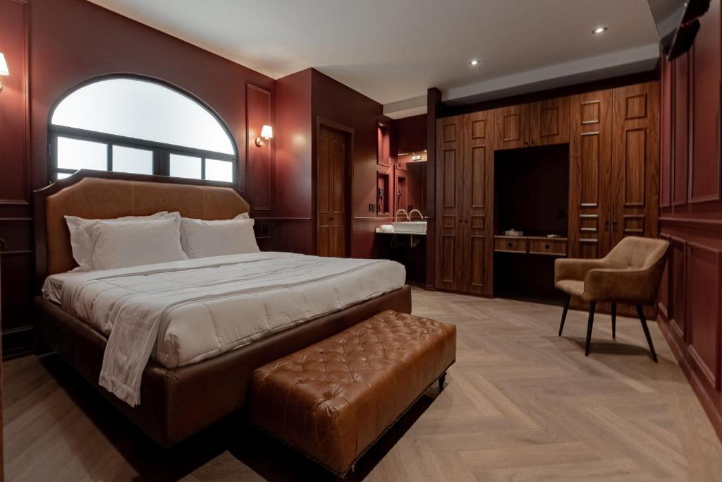 a bedroom with a large bed and a bathroom at The Urban Muse suite in Mexico City