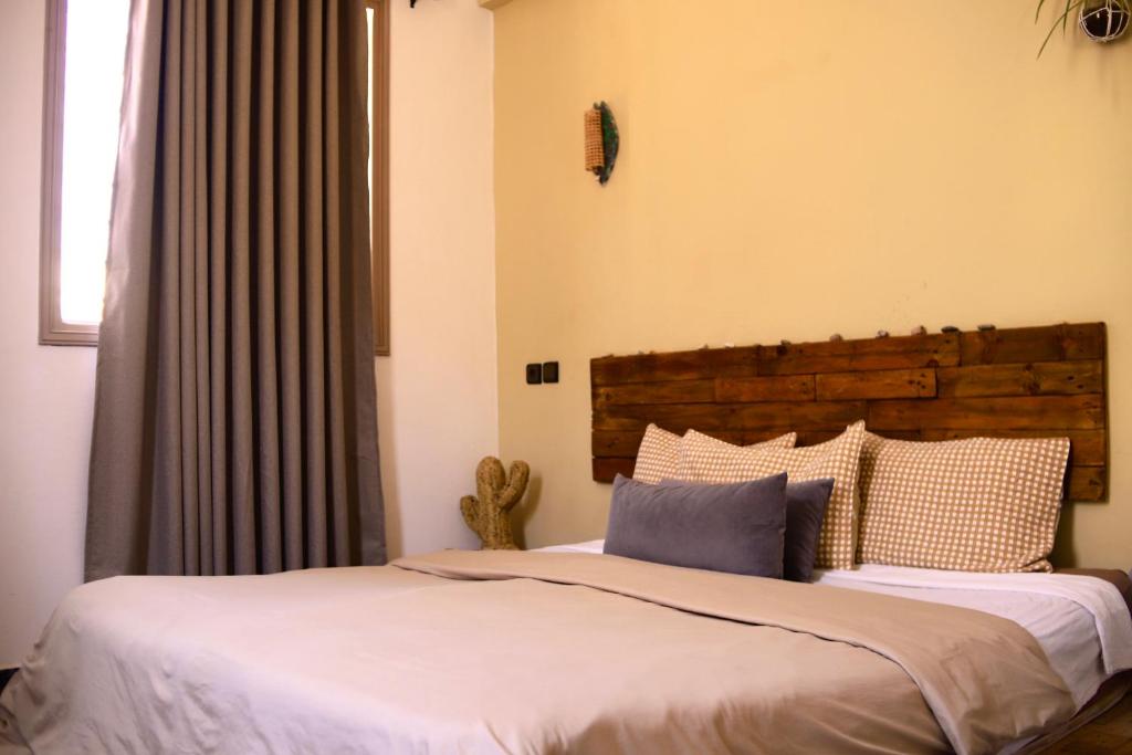 a bedroom with two beds and a window at The FlowHost in Tamraght Ouzdar