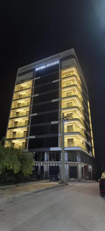 a tall building with lights on it at night at Luxury Apartment in Tlemcen
