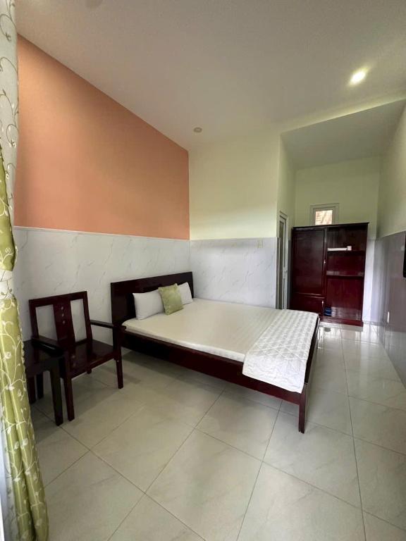 a bedroom with a large bed and a chair at Hotel Song biển in Phan Thiet