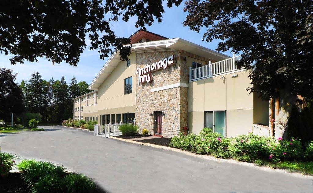 an exterior view of a hotel with a parking lot at Anchorage Inn & Suites - Portsmouth in Portsmouth