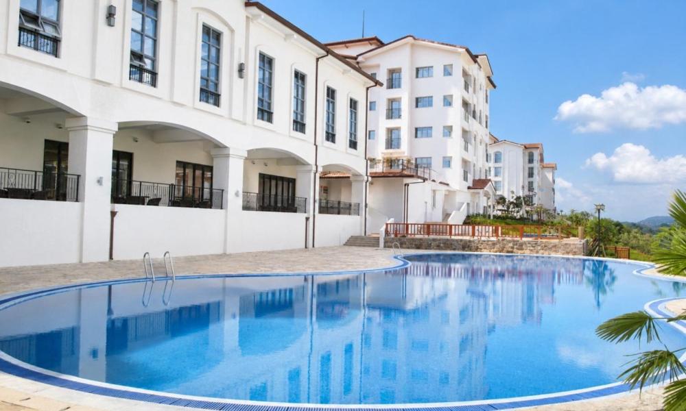 a swimming pool in front of a building at Sagewood Yeosu Gyeongdo Resort in Kyŏngho-dong
