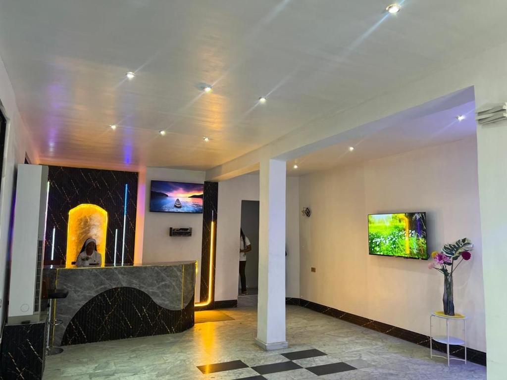 a lobby with a reception desk and a painting on the wall at Arrabella Masaki in Dar es Salaam