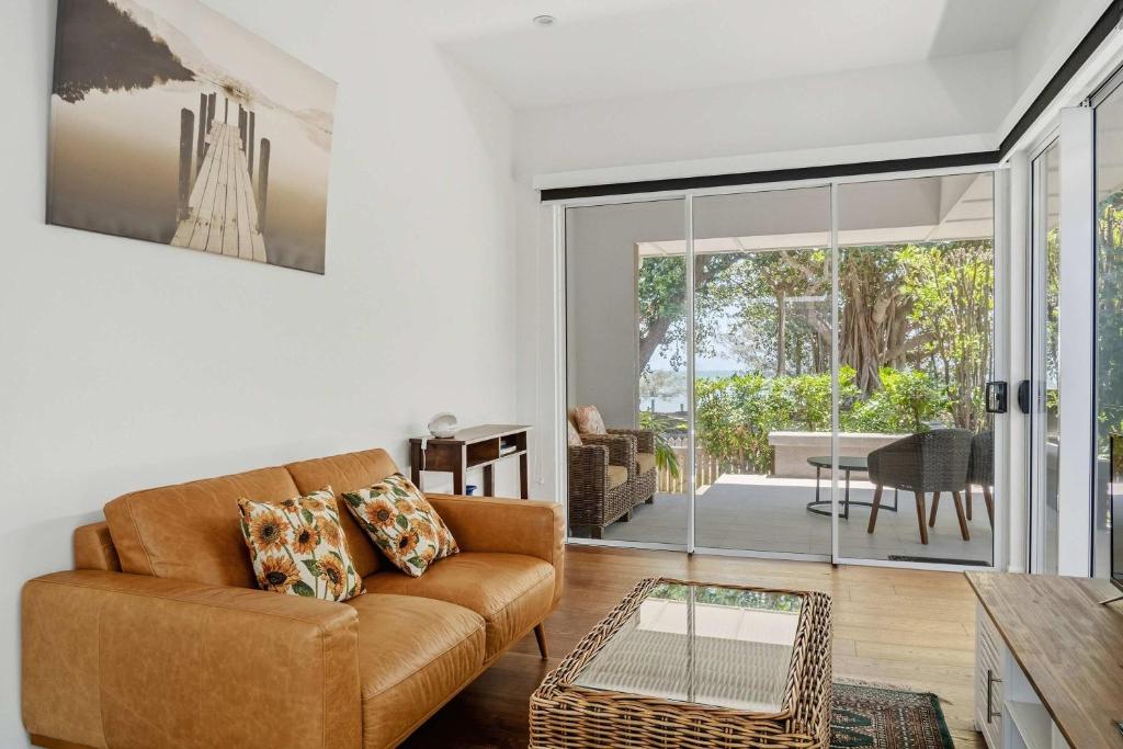 a living room with a couch and a table at Reflections Turquoise Villa 4 in Picnic Bay