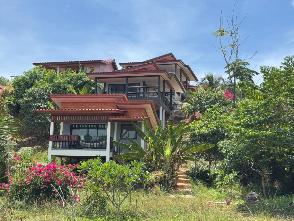 a house on top of a hill with flowers at Leam Sai Seaview in Ban Laem Sai