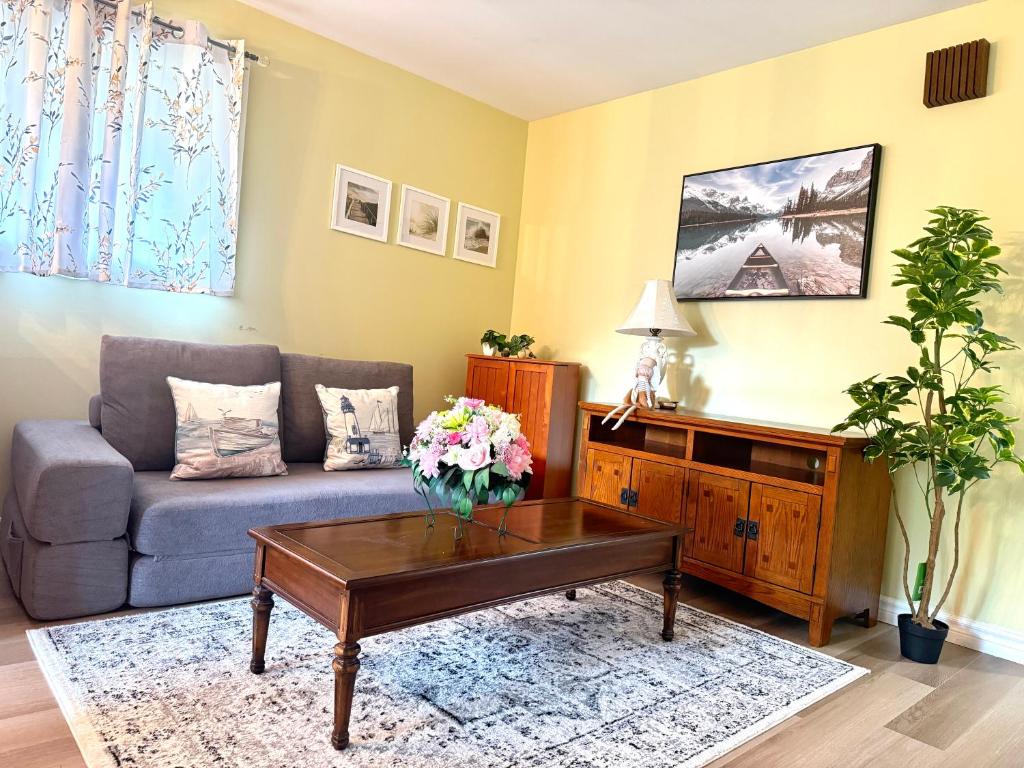 a living room with a couch and a coffee table at Private Guest Suit-Self Checkin-Near Downtown in Charlottetown