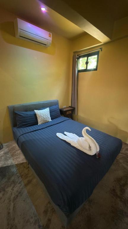 a bedroom with a bed with a swan on it at One bedroom apartment Hin Kong in Ko Phangan