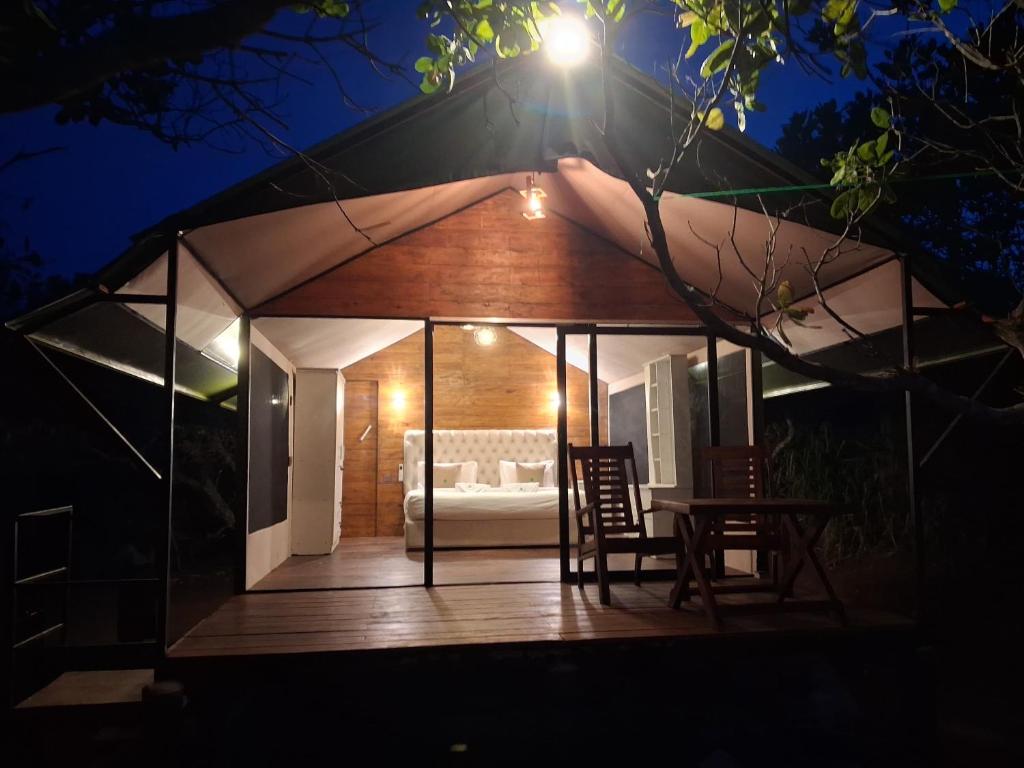 a gazebo with a couch in it at night at Wilpattu Wilderness Camping in Wilpattu