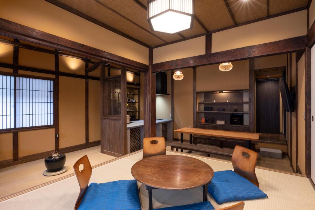 a living room with a wooden table and chairs at Temple Stay KAN 観 in Yokosuka