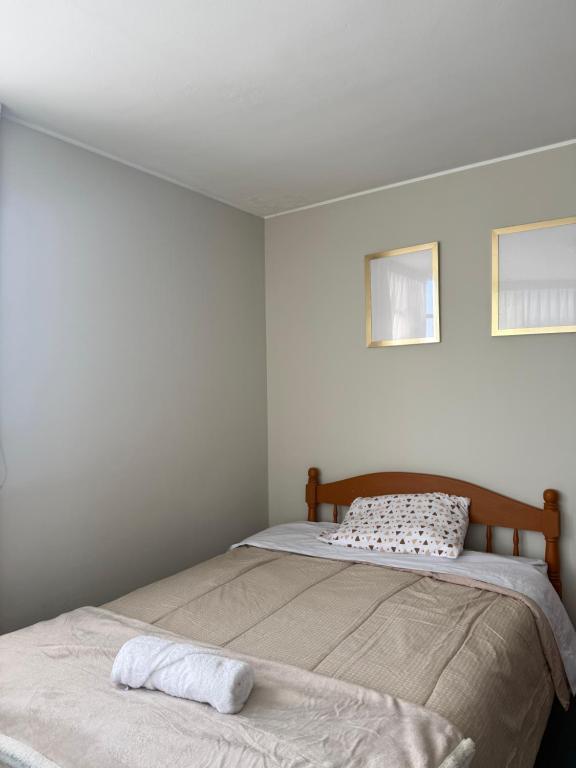 a bedroom with two beds and a pillow on top at Oasis in Tacna