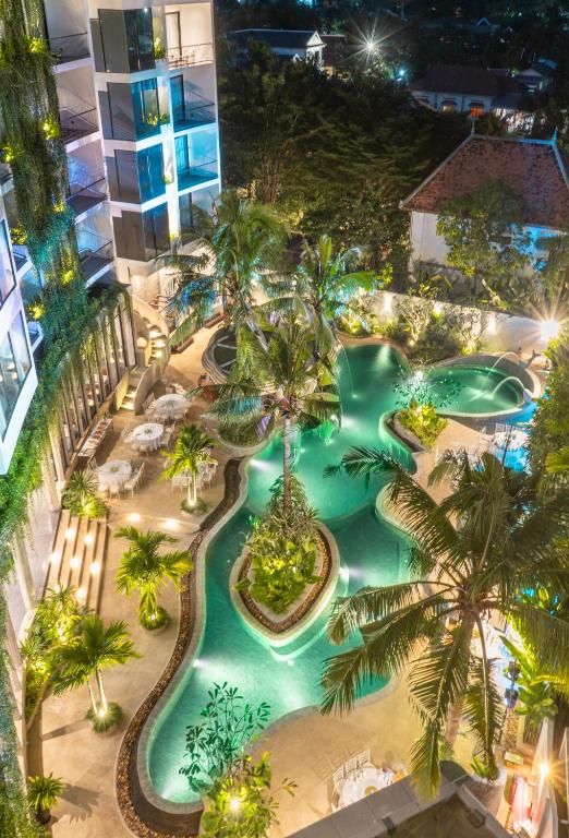 an aerial view of a pool at a resort at night at Hotel Vellita Siem reap in Siem Reap