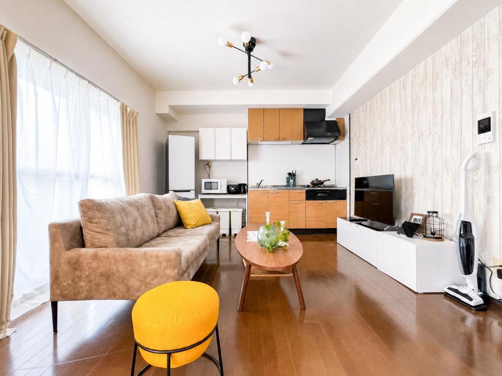 a living room with a couch and a table at サンヒルズマンション in Tosu