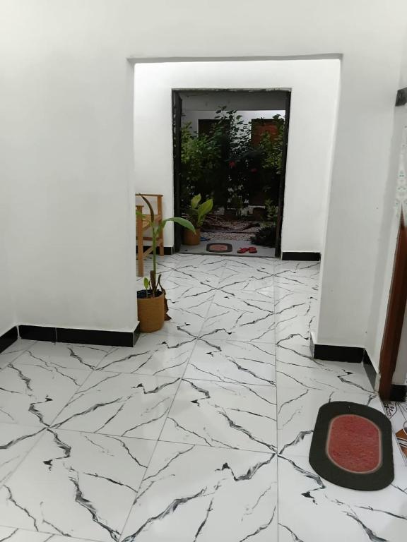 a room with a marble floor and a doorway at Casa twende A in Nungwi
