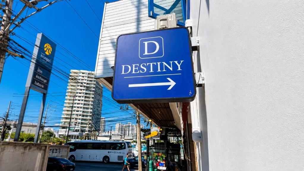 a blue sign on a building that says d destiny at Destiny Hostel Pattaya in Jomtien Beach