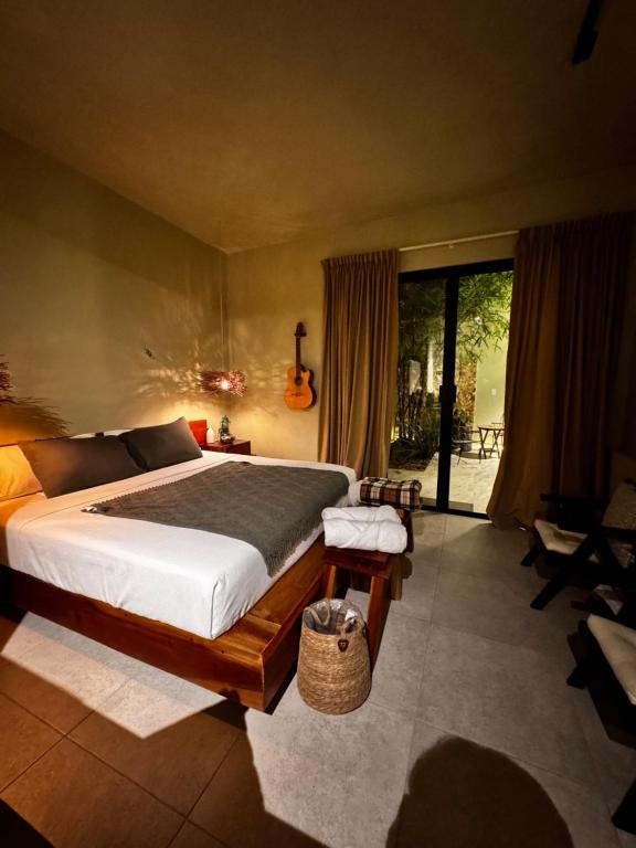 a bedroom with a large bed and a balcony at Bernardino in Valladolid