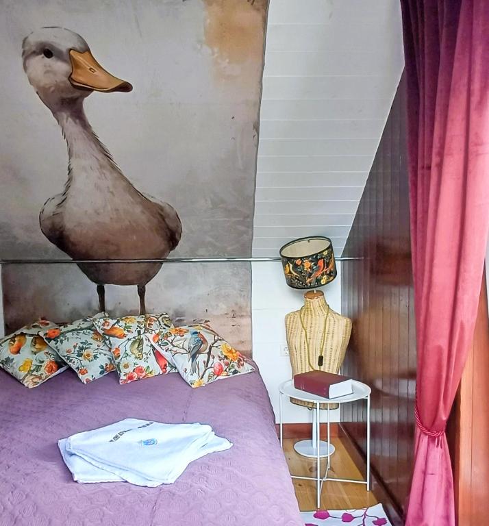 a bedroom with a stuffed duck on the bed at iNKiLAS KLIUKAI in Bijutiškis