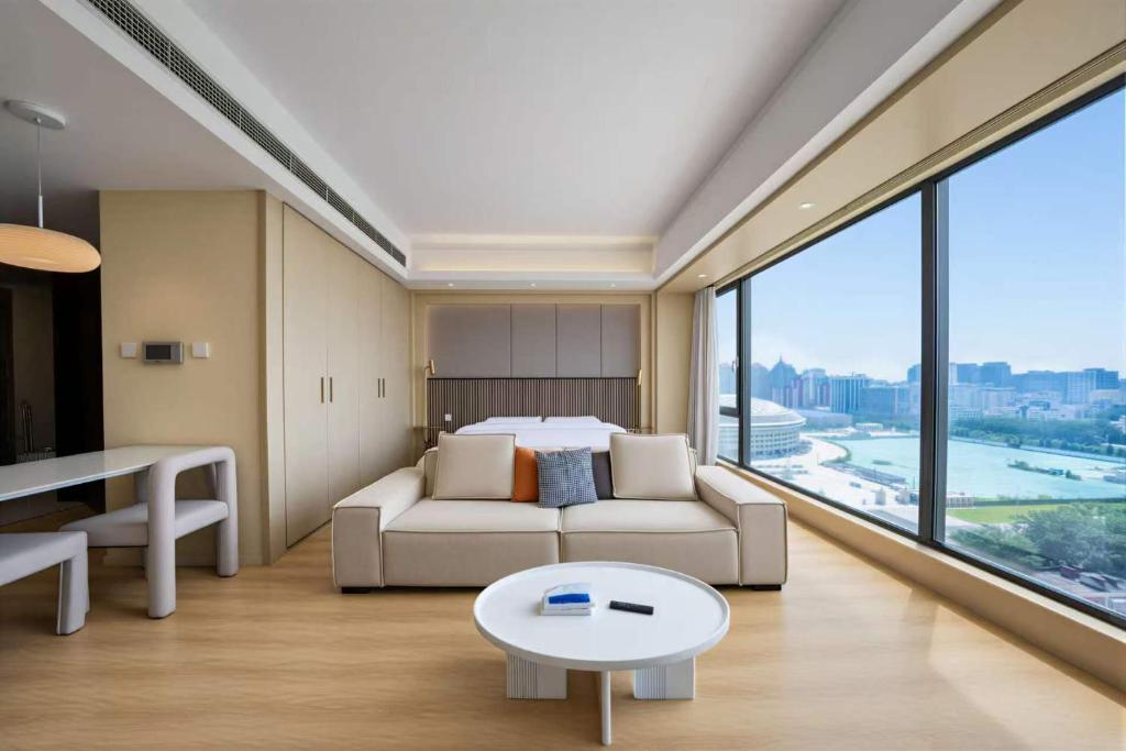 a room with a couch and a bed and a table at 栖雅民宿 in Beijing