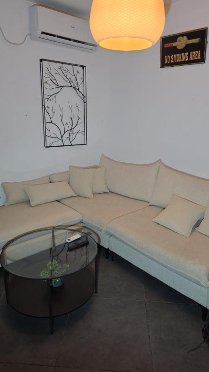 a living room with a couch and a coffee table at BOND Grand Suites in Beer Sheva