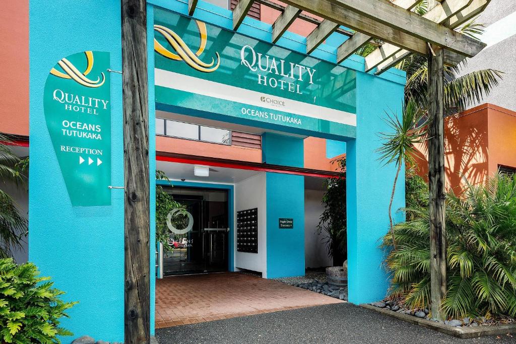 a blue building with a sign that readsquality hotel at Quality Hotel Oceans Tutukaka in Tutukaka