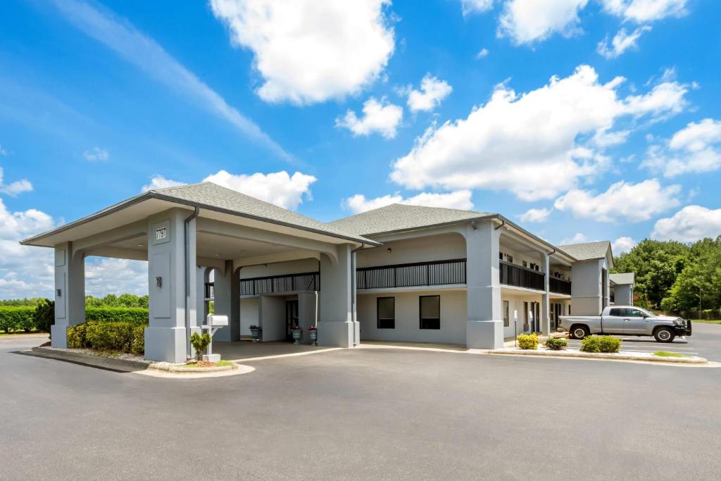 a large white building with a parking lot at Quality Inn Battleboro - Rocky Mount in Battleboro