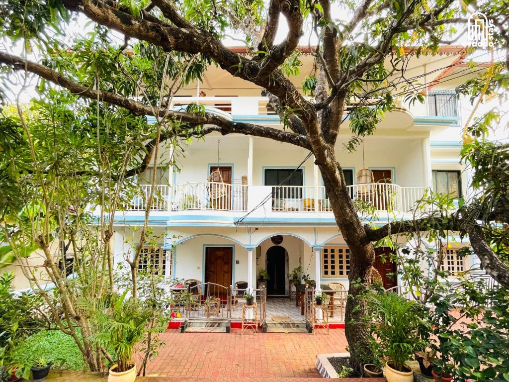 a view of the front of a house with trees at Aamra Ghar by evaddo stays in Mandrem