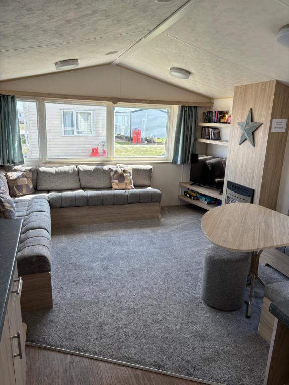 a living room with a couch and a table at TSCaravan, Haven, Golden Sands in Mablethorpe