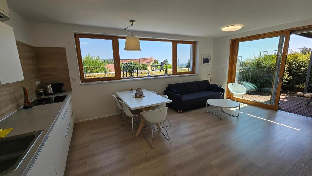 a kitchen and living room with a couch and a table at Rezidence Pavlov in Pavlov