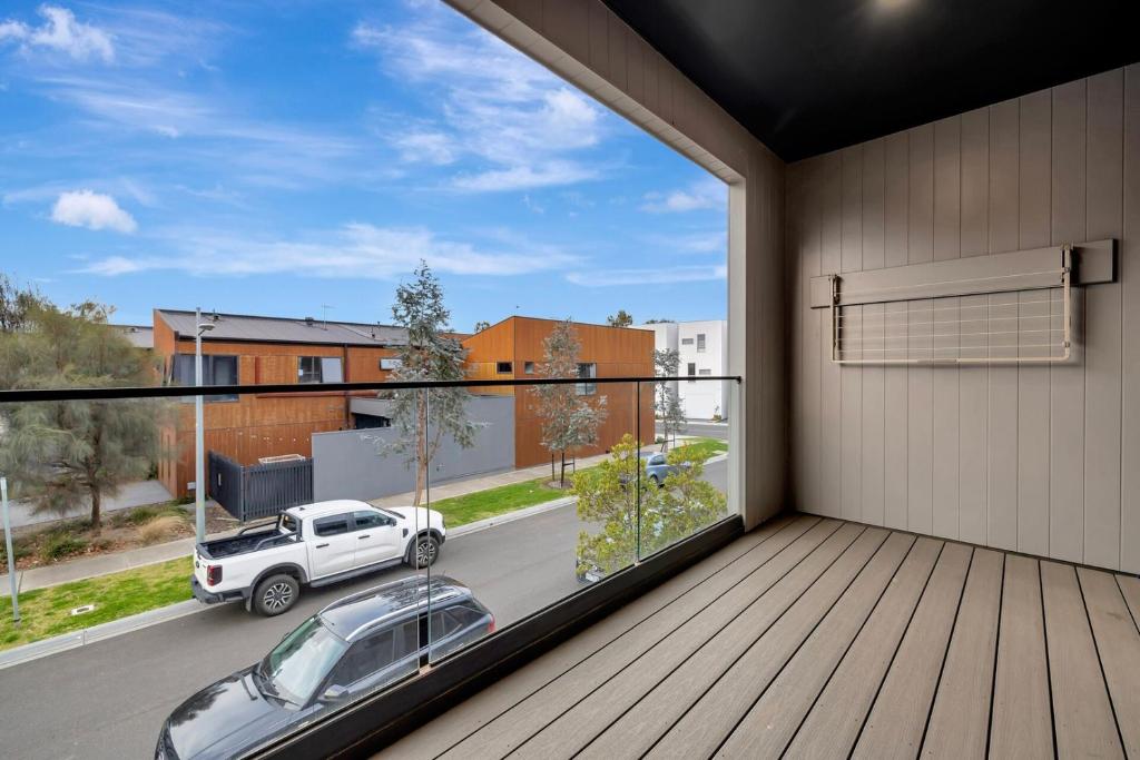 a view from the balcony of a house with a car at Stylish 3-Bedroom Townhouse Near Shops & Parks in Point Cook