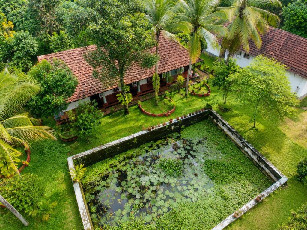 an aerial view of a garden in front of a house at Sea Mist Beach Villas Alleppey in Alleppey