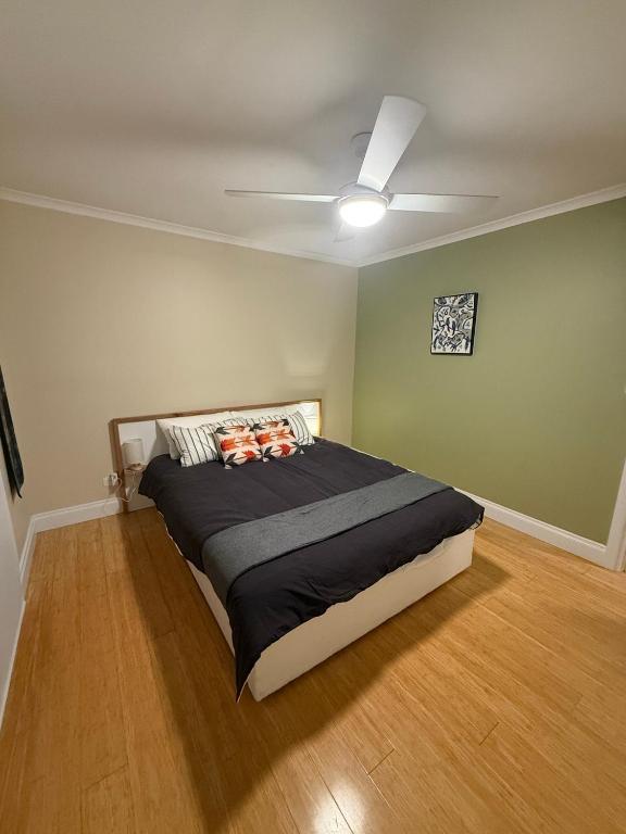 a bedroom with a bed with a ceiling fan at Yokomokko House in Bridgewater