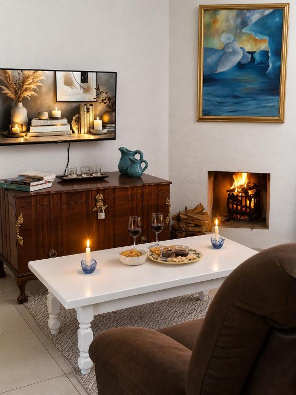 a living room with a table and a fireplace at Eucalyptus Cottage in Cape Town
