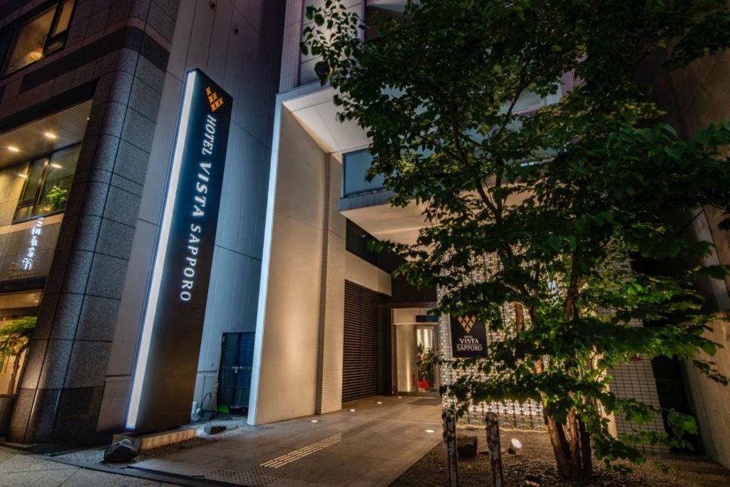 a building with a sign on the side of it at Hotel Vista Sapporo Odori in Sapporo