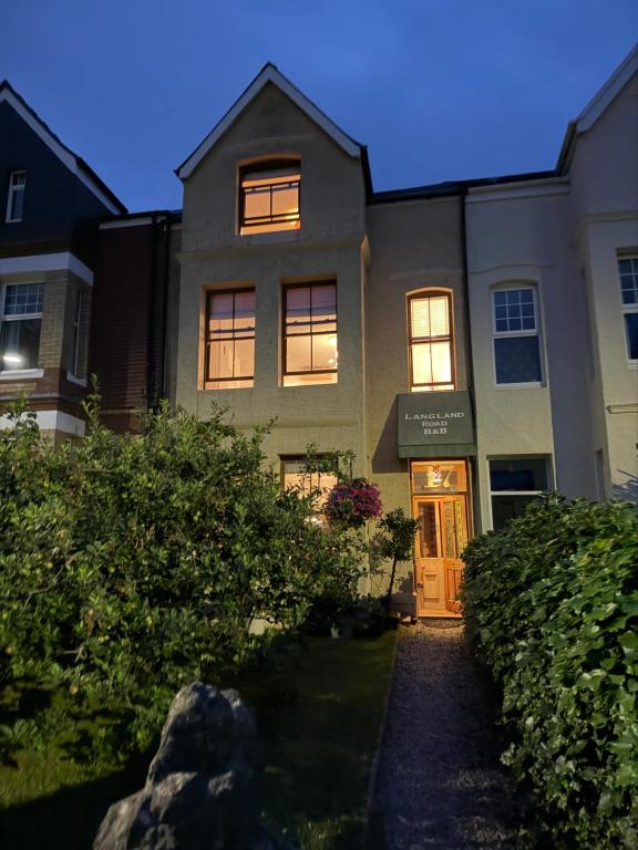 a house with its door open on a street at Langland Road B&B in The Mumbles