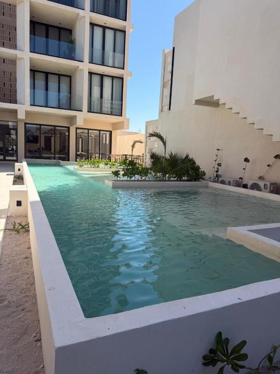 a swimming pool in front of a building at Bajareque Oceanfront Luxury 3 BR Villa in Telchac Puerto