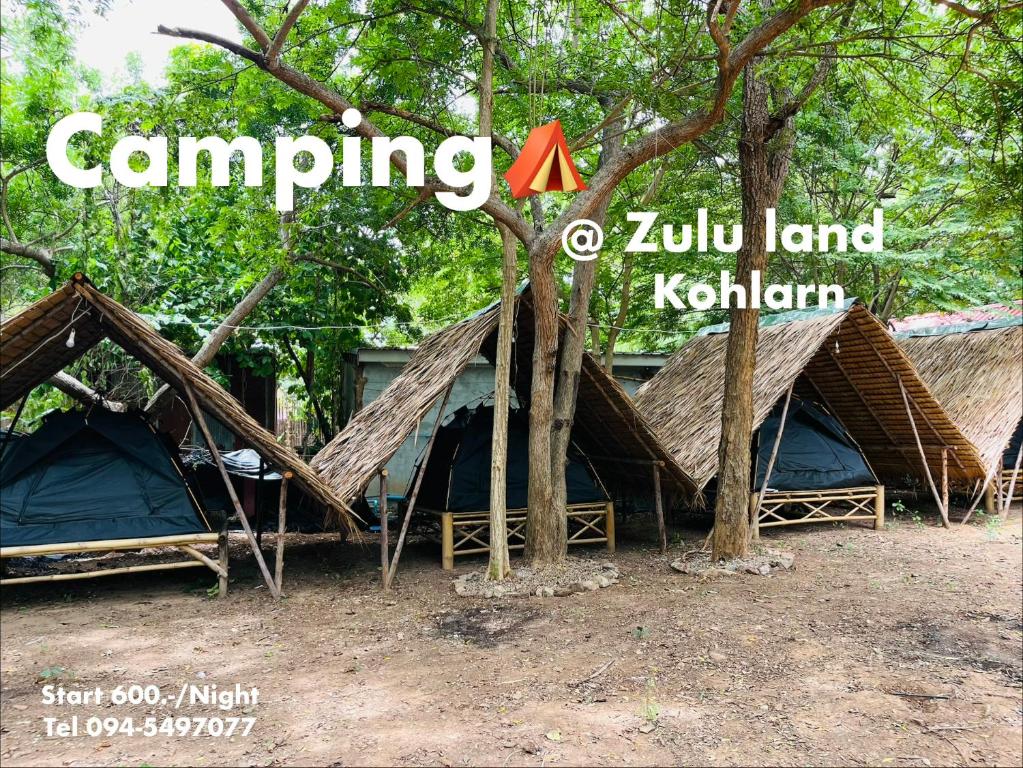 a group of tents under trees with the words camping at Zulu land Kohlarn in Ko Lan