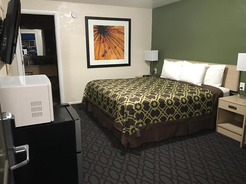 a hotel room with a bed and a picture on the wall at Downtown Inn in Eugene