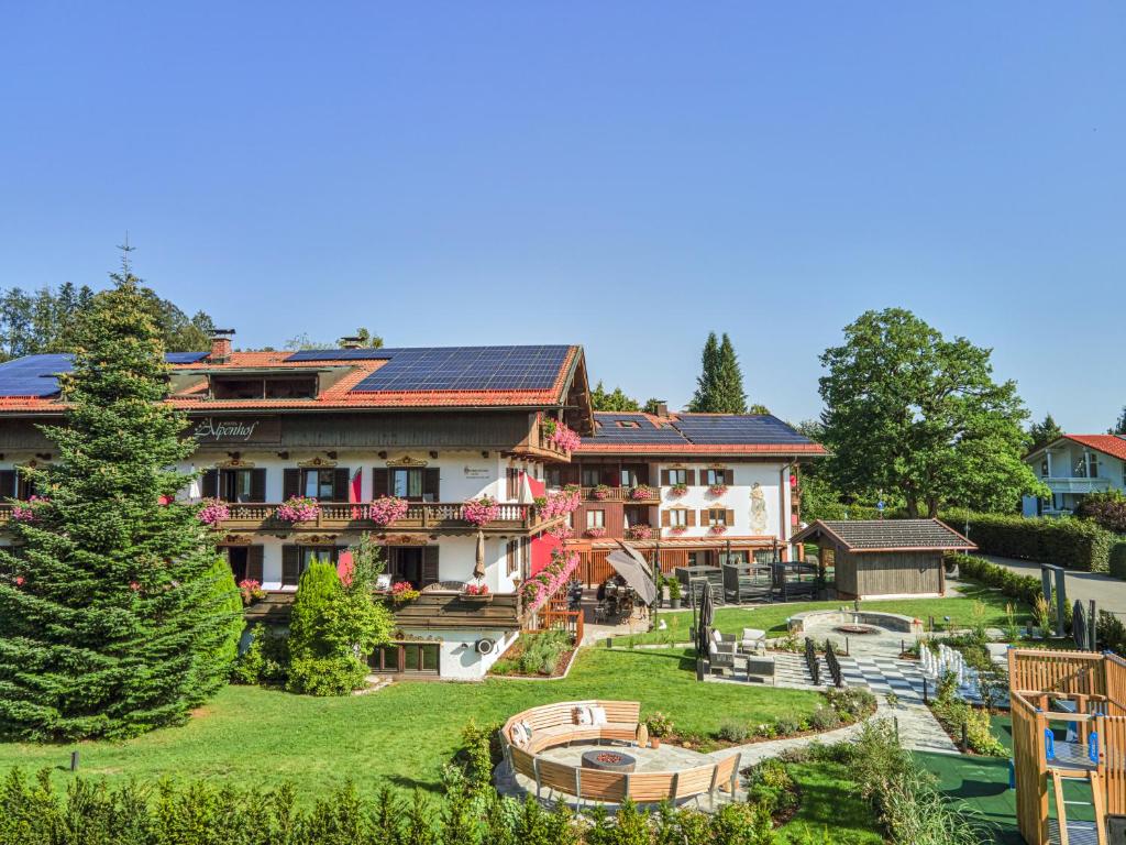 a large house with solar panels on its roof at Hotel Alpenhof in Bad Wiessee