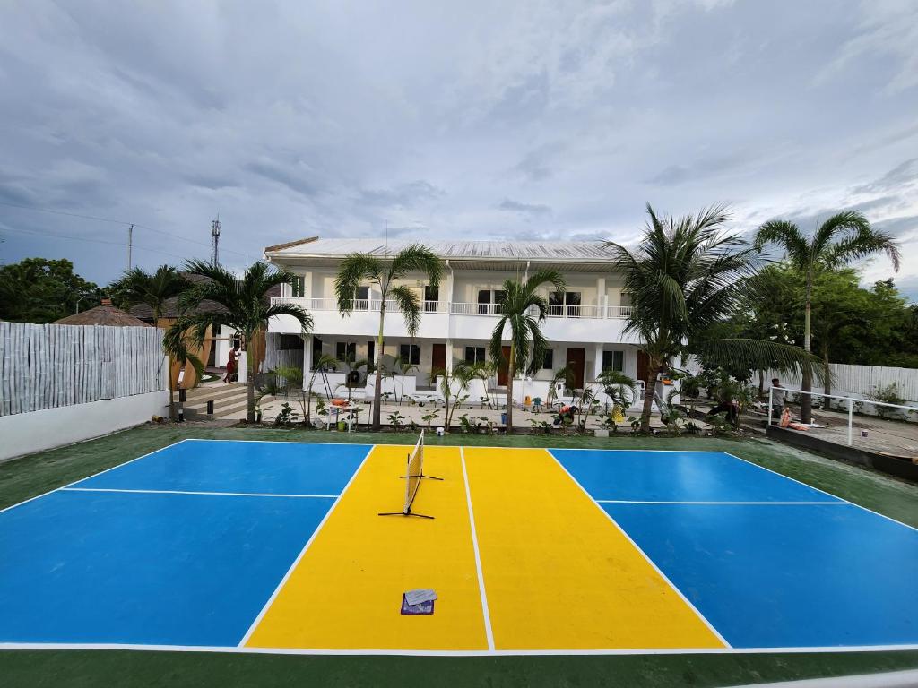 a tennis court in front of a house at Beyond Island Resort in Moalboal