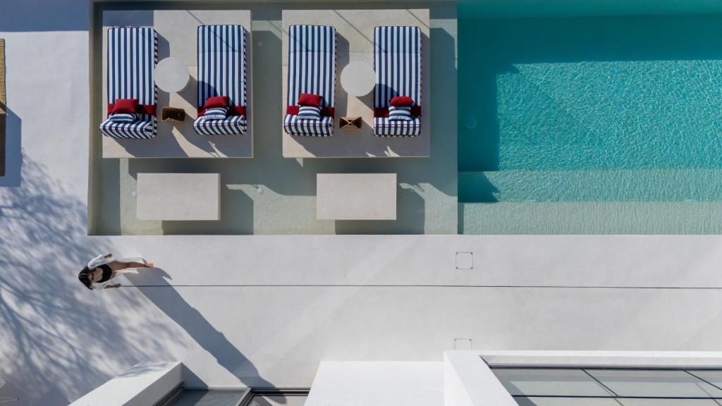 a bathroom with a row of chairs on a wall at CAPO LEFKADA Villa 71 - Sea View - Two Private Pools in Tsoukalades