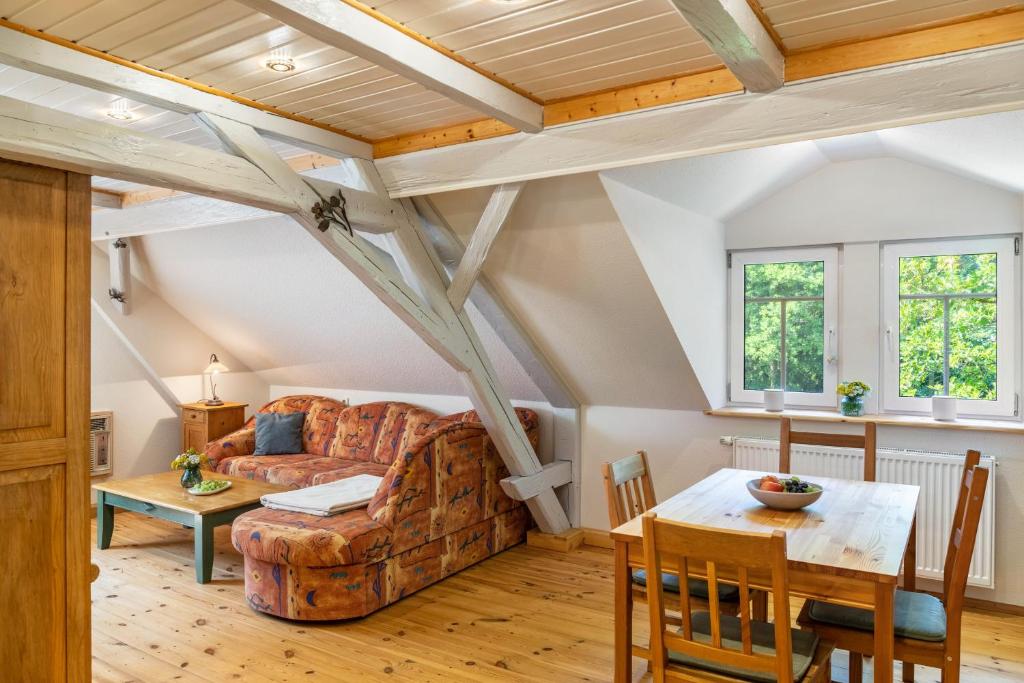 a living room with a couch and a table at Ferienwohnung Schwarzmühle 3 in Neuer Anbau