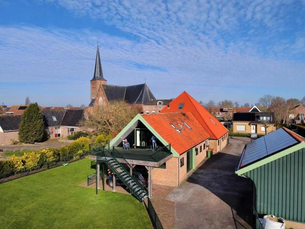 an aerial view of a building with a church at Chez Marly in Oosterblokker