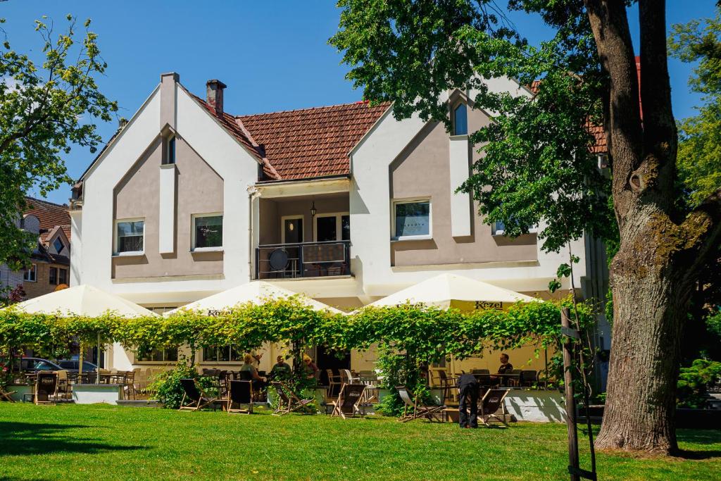 a large house with a lawn in front of it at Parkova - pokoje hotelowe in Gołdap