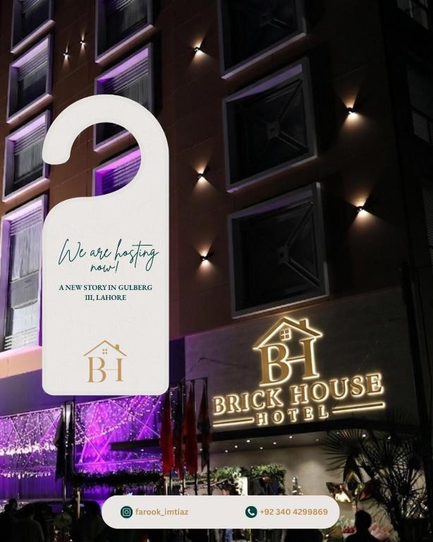 a sign for the brick house hotel in front of a building at Brick House Hotel Lahore in Lahore