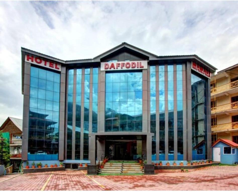 a large building with a sign on top of it at New Daffodil Classic Manali in Manāli