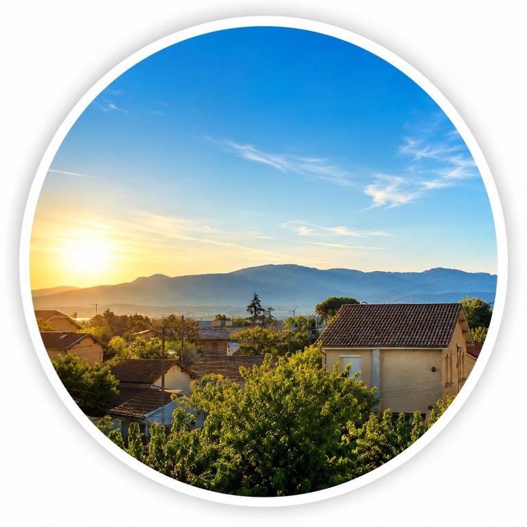 a round picture of a city with the sunset in the sky at Feutres et Formes in Bourg-de-Péage