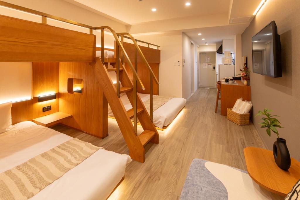 a room with two bunk beds and a desk at NOVI Dotonbori in Osaka